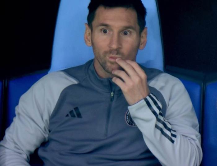 Lionel Messi pictured looking shocked on the Inter Miami bench after seeing his team concede three goals inside the first 12 minutes of a game against Al Nassr in February 2024